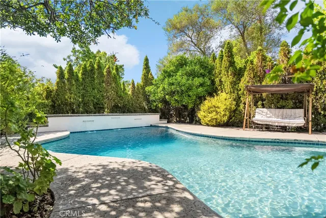 an aerial view of a house with yard swimming pool and outdoor seating