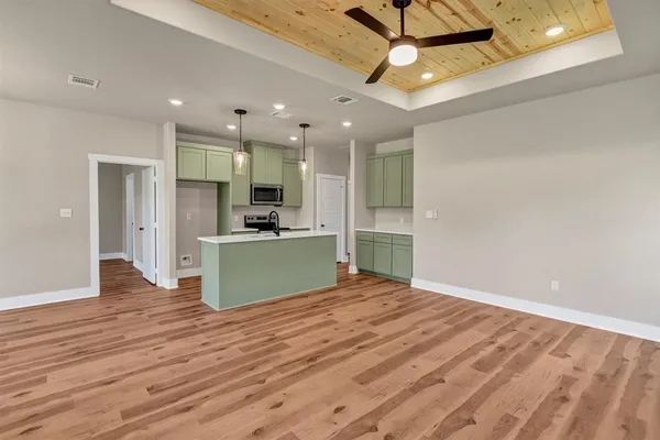 a view of kitchen and hall with wooden floor