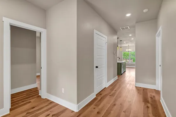 a view of a hallway with wooden floor