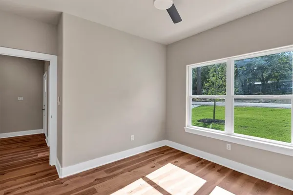 wooden floor in an empty room with a window