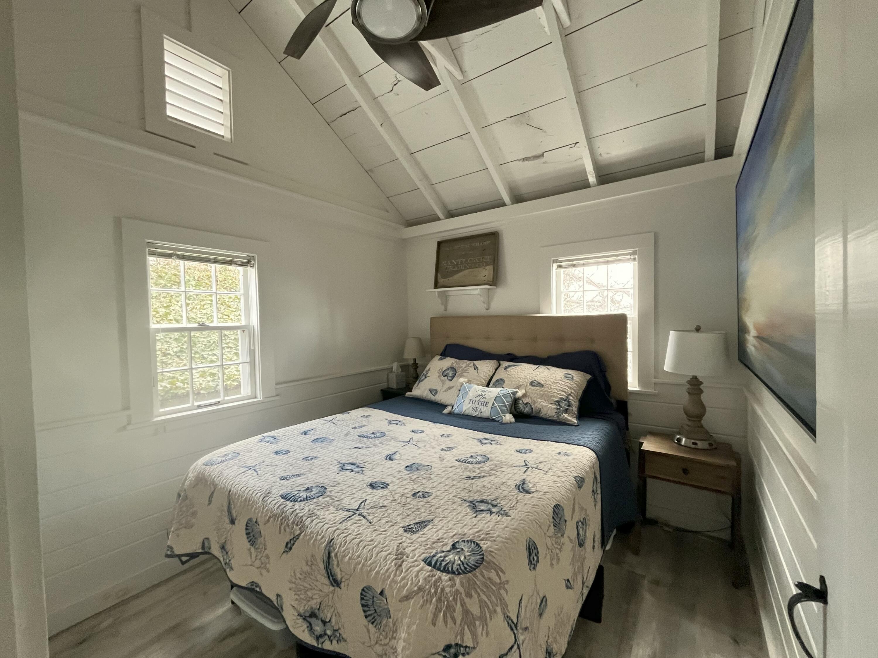 241 Old Wharf Road, Unit 162 Dennis Port, MA 02639 - Photo 12 of 28 a bedroom with a bed and wooden floor