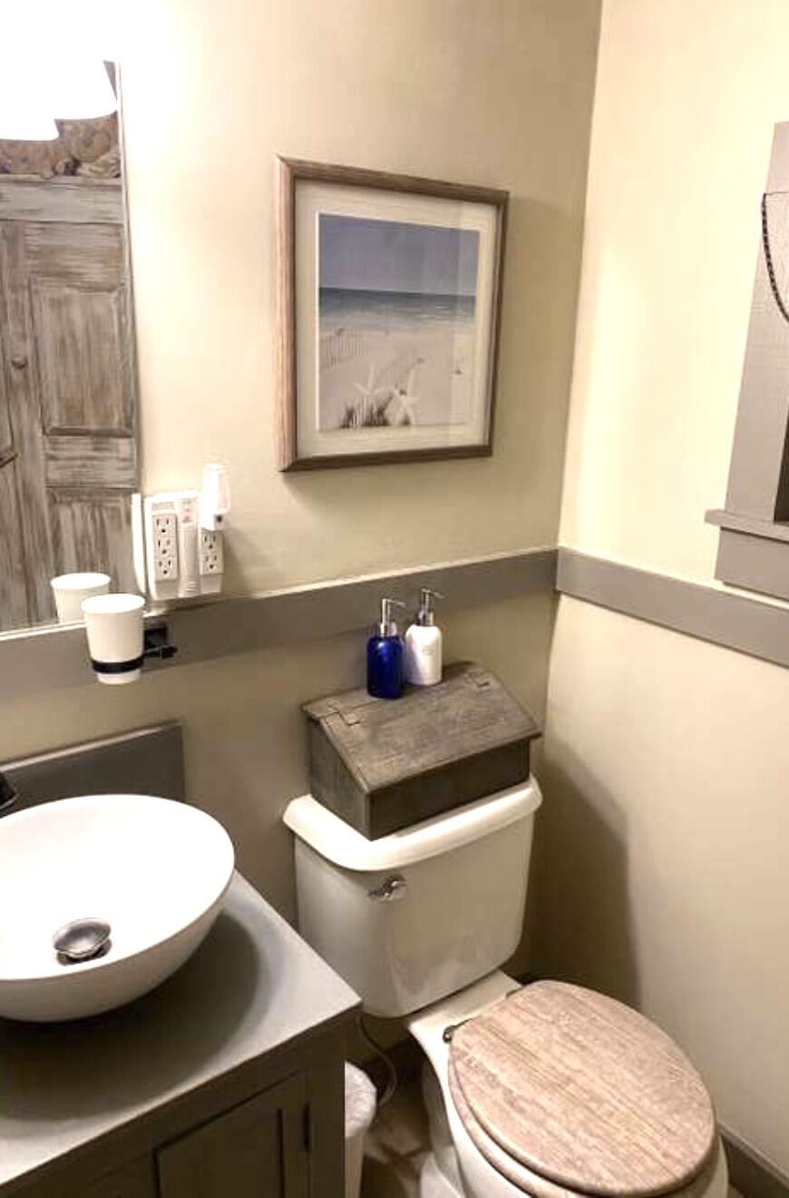 241 Old Wharf Road, Unit 162 Dennis Port, MA 02639 - Photo 15 of 28 a bathroom with a toilet a sink and mirror