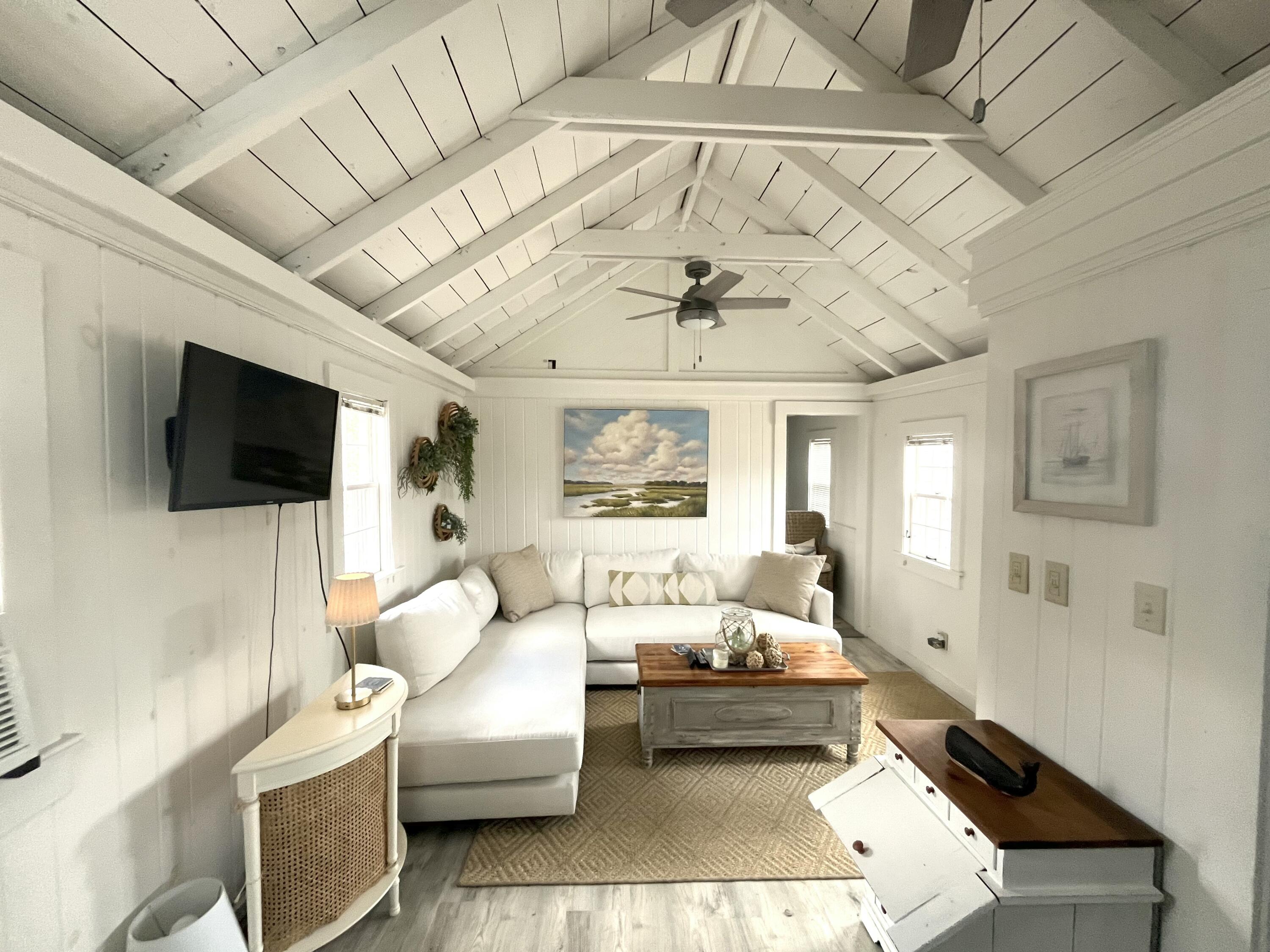 241 Old Wharf Road, Unit 162 Dennis Port, MA 02639 - Photo 3 of 28 a living room with furniture and a flat screen tv