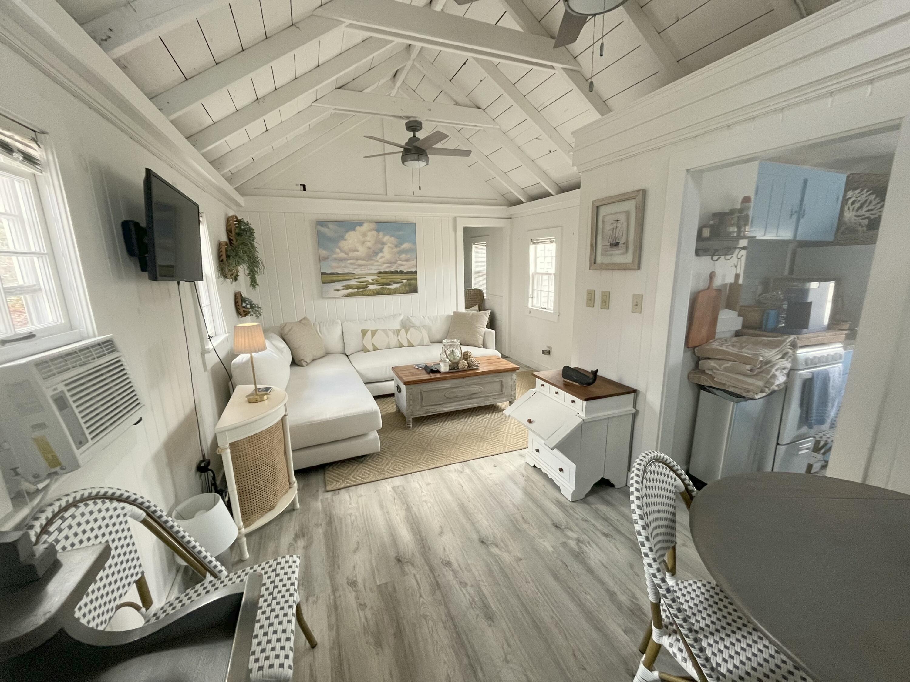 241 Old Wharf Road, Unit 162 Dennis Port, MA 02639 - Photo 4 of 28 a living room with furniture a fireplace and a flat screen tv