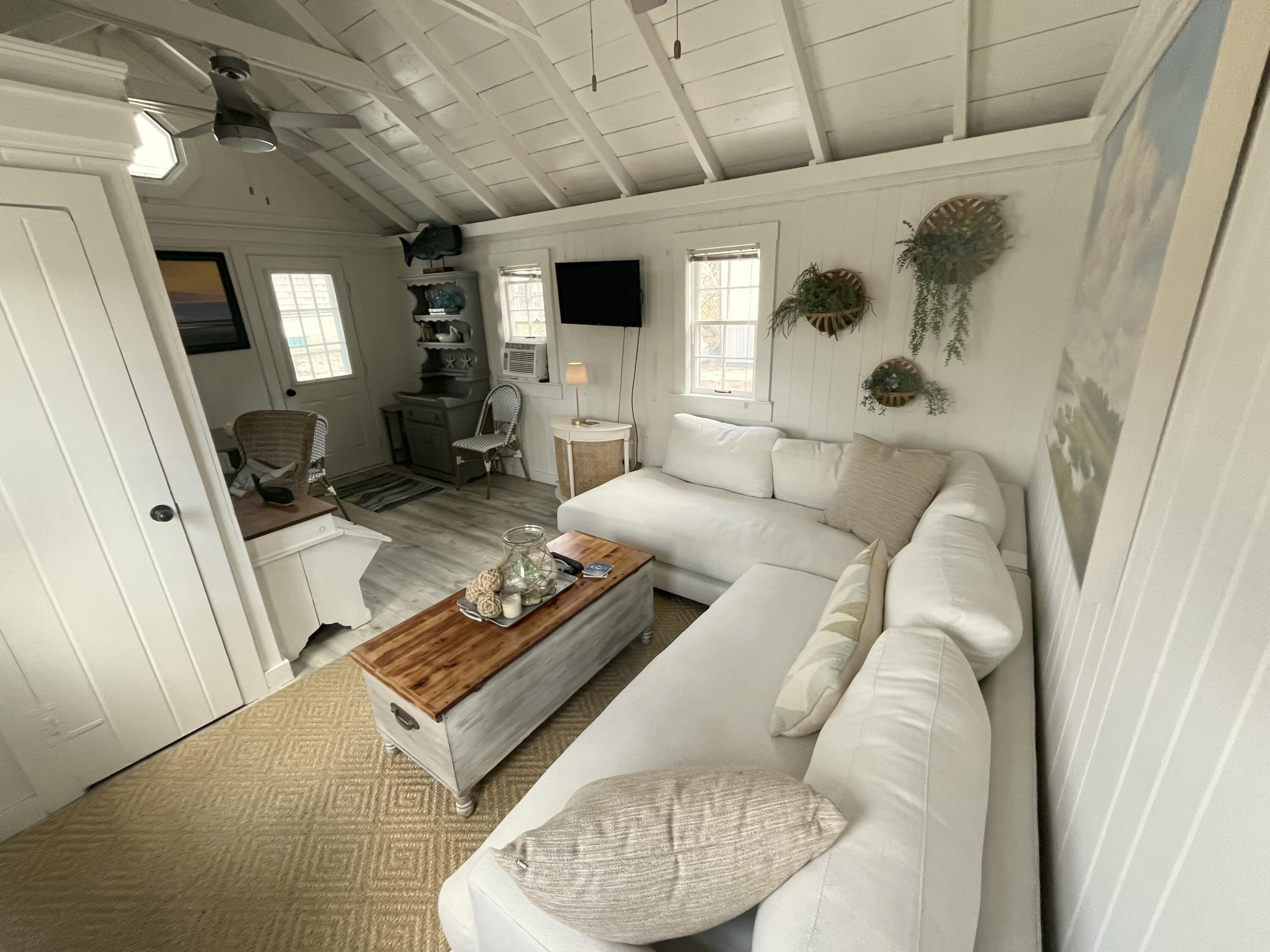 241 Old Wharf Road, Unit 162 Dennis Port, MA 02639 - Photo 6 of 28 a living room with furniture and a flat screen tv