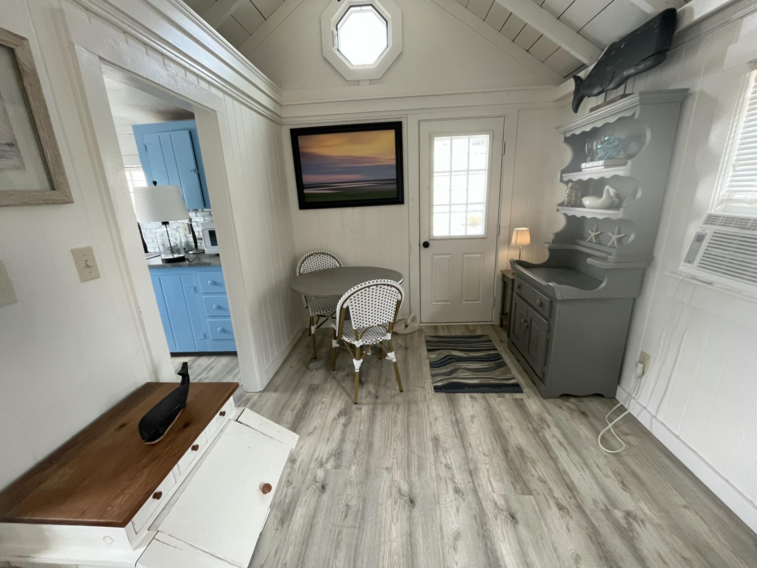 241 Old Wharf Road, Unit 162 Dennis Port, MA 02639 - Photo 7 of 28 a view of a living room with furniture and a mirror