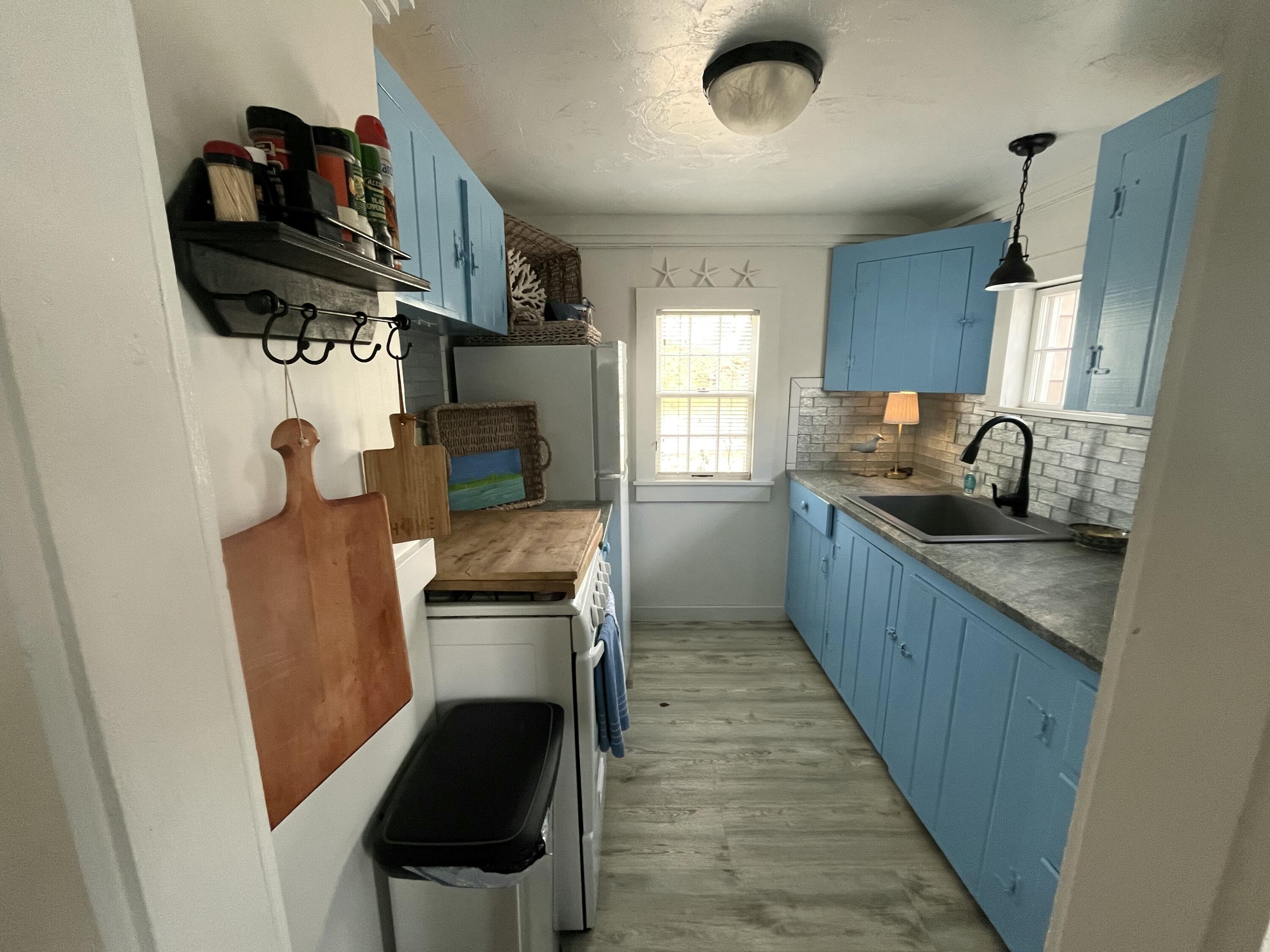 241 Old Wharf Road, Unit 162 Dennis Port, MA 02639 - Photo 8 of 28 a kitchen with stainless steel appliances granite countertop a sink stove and refrigerator