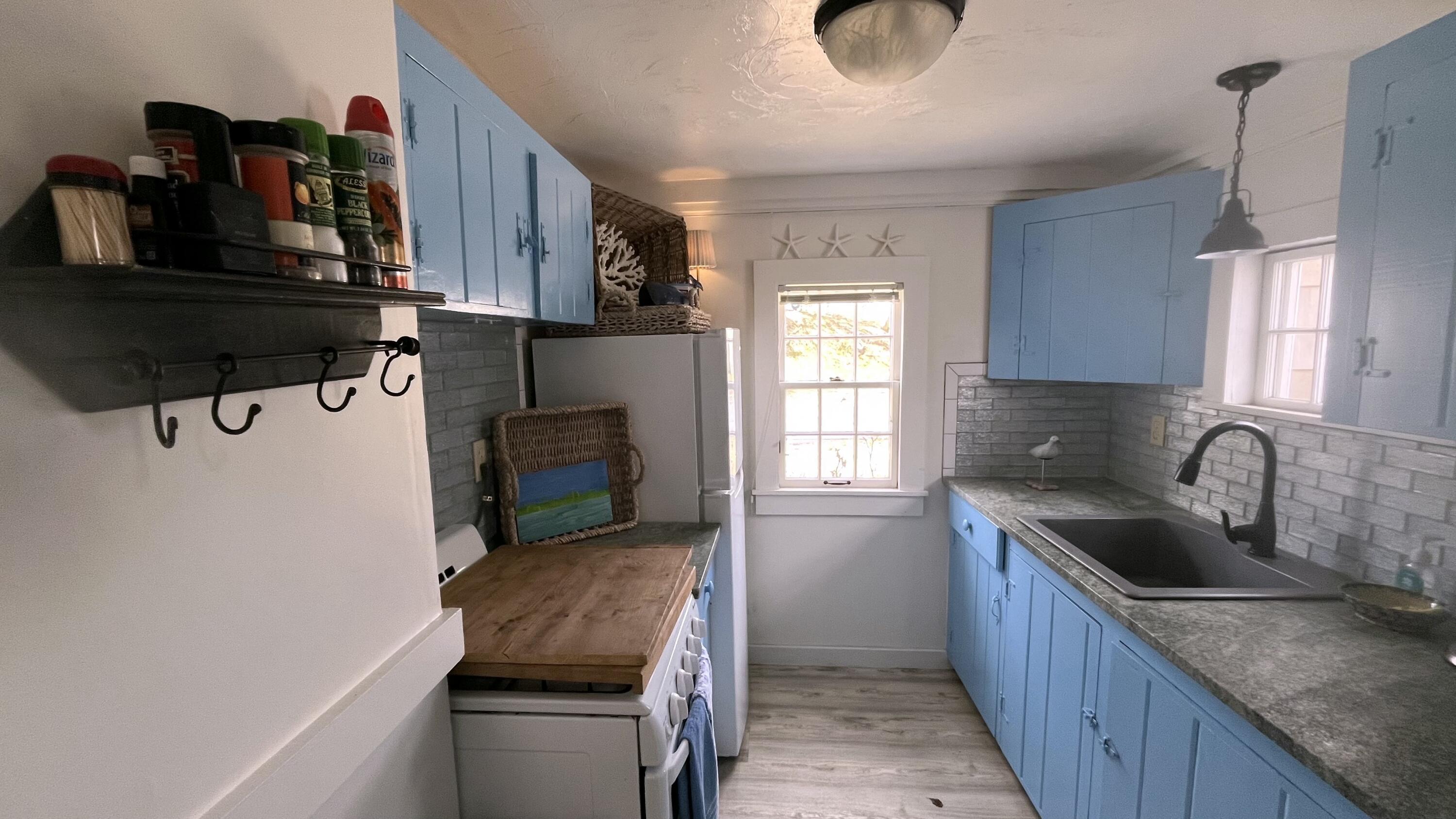 241 Old Wharf Road, Unit 162 Dennis Port, MA 02639 - Photo 9 of 28 a kitchen with a refrigerator and a sink