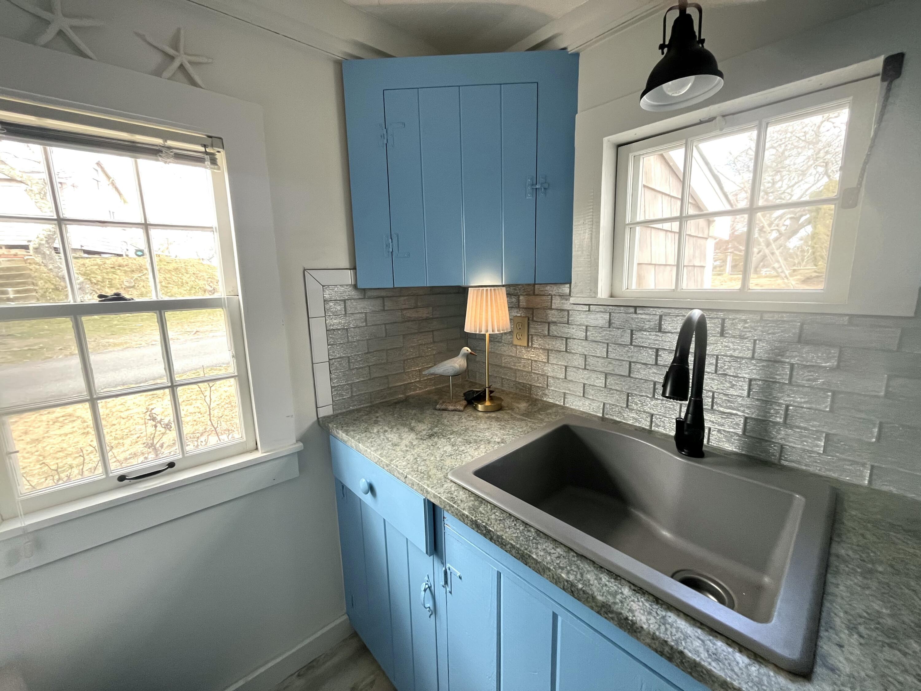 241 Old Wharf Road, Unit 162 Dennis Port, MA 02639 - Photo 10 of 28 a kitchen with granite countertop a sink a window and stainless steel appliances