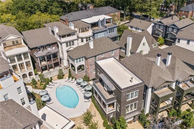 an aerial view of residential house with outdoor space and seating space