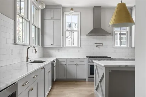 a kitchen with stainless steel appliances a sink stove and cabinets