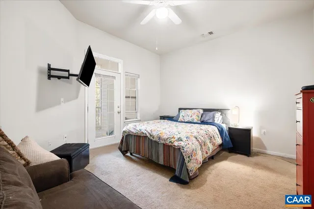 a bedroom with a bed and a couch