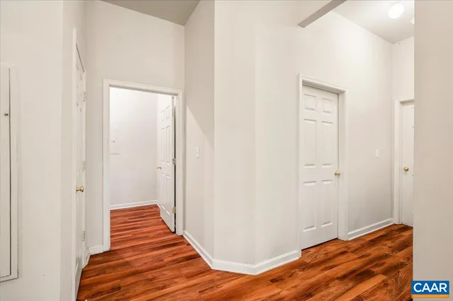a view of a hallway with wooden floor