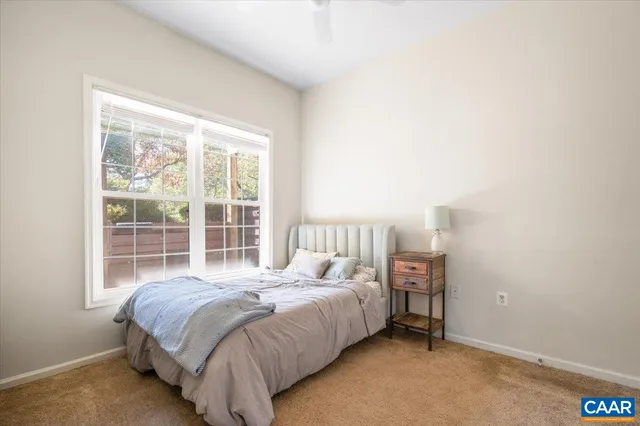 a bedroom with a bed and window