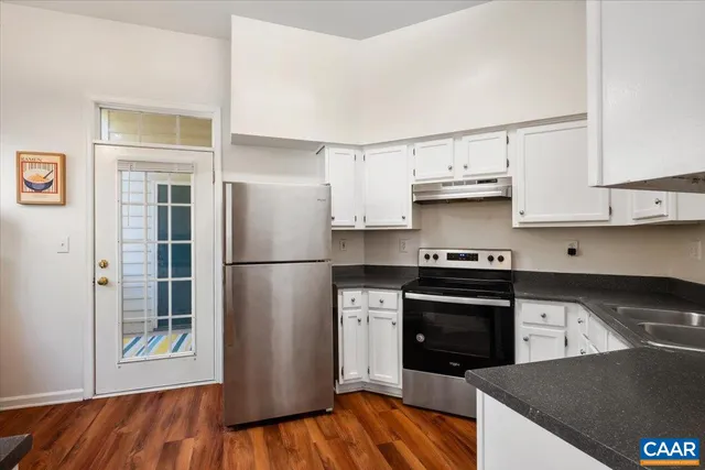 a kitchen with stainless steel appliances granite countertop a refrigerator stove and sink