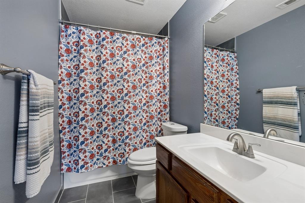 129 Timberbluff Lane Murphy, TX 75094 - Photo 27 of 34 a bathroom with a sink toilet and shower