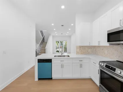 a kitchen with a sink stove and microwave