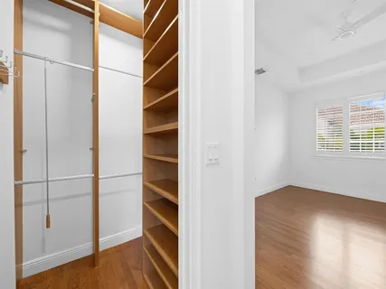 a view of walk in closet with empty racks