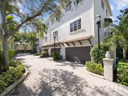 a front view of a house with a yard and a garden