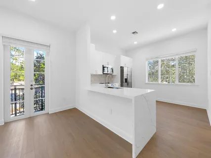 a view of kitchen with furniture and wooden floor