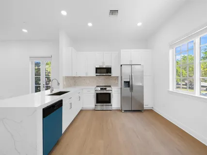 a kitchen with stainless steel appliances a stove sink and refrigerator