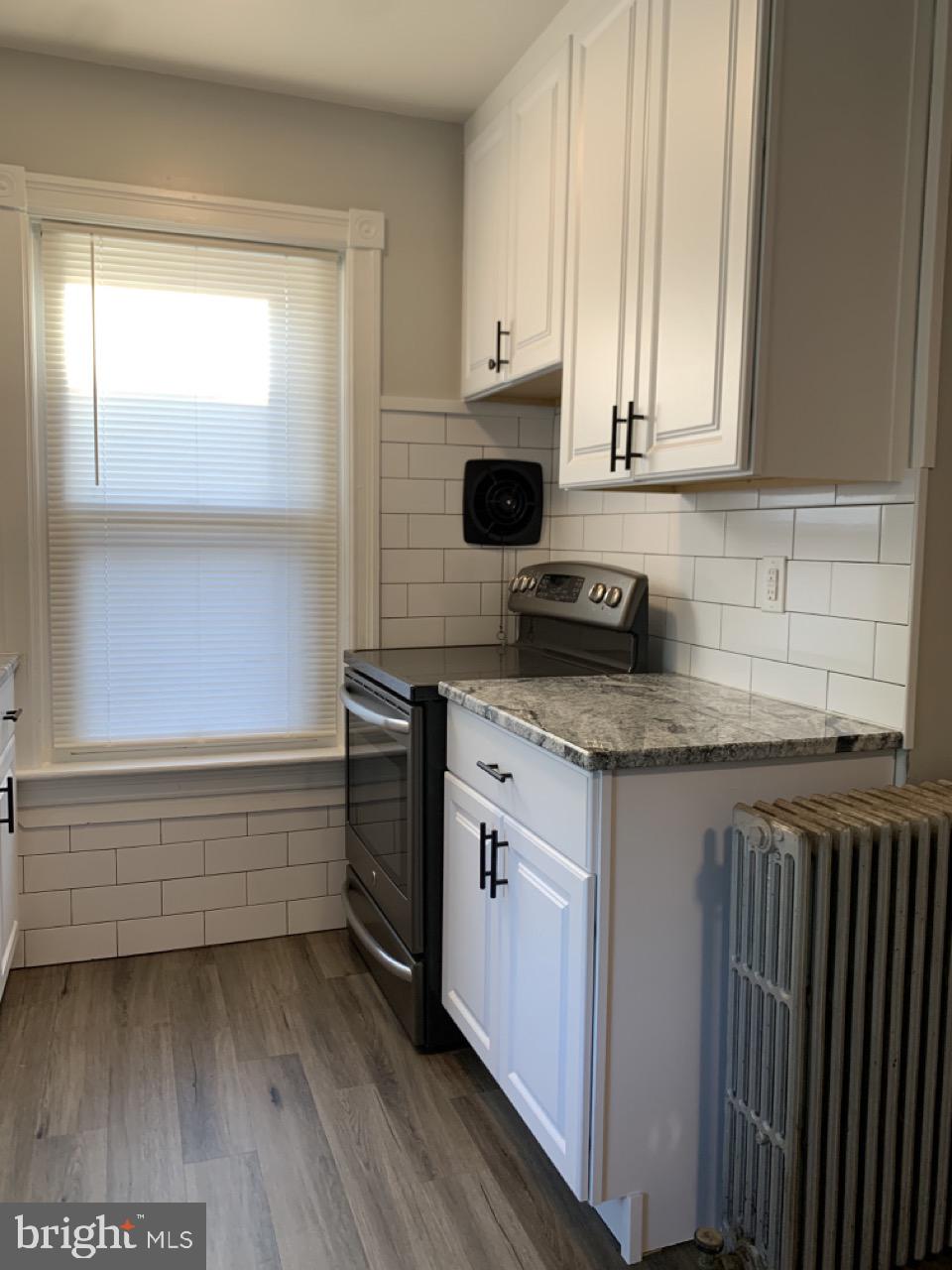512 3rd Street, Unit 2 East Greenville, PA 18041 - Photo 3 of 11 a kitchen with granite countertop a sink and a stove next to a window