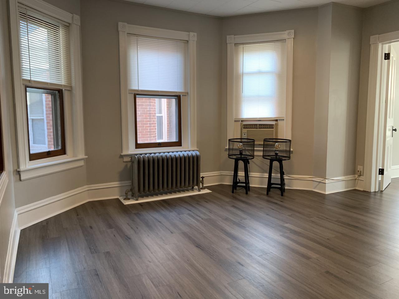 512 3rd Street, Unit 2 East Greenville, PA 18041 - Photo 7 of 11 an empty room with wooden floor and windows