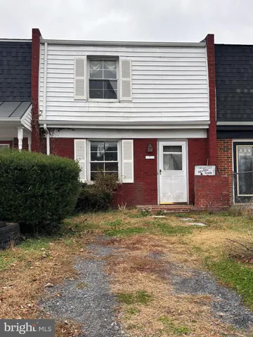 a house that has a large tree in front of it
