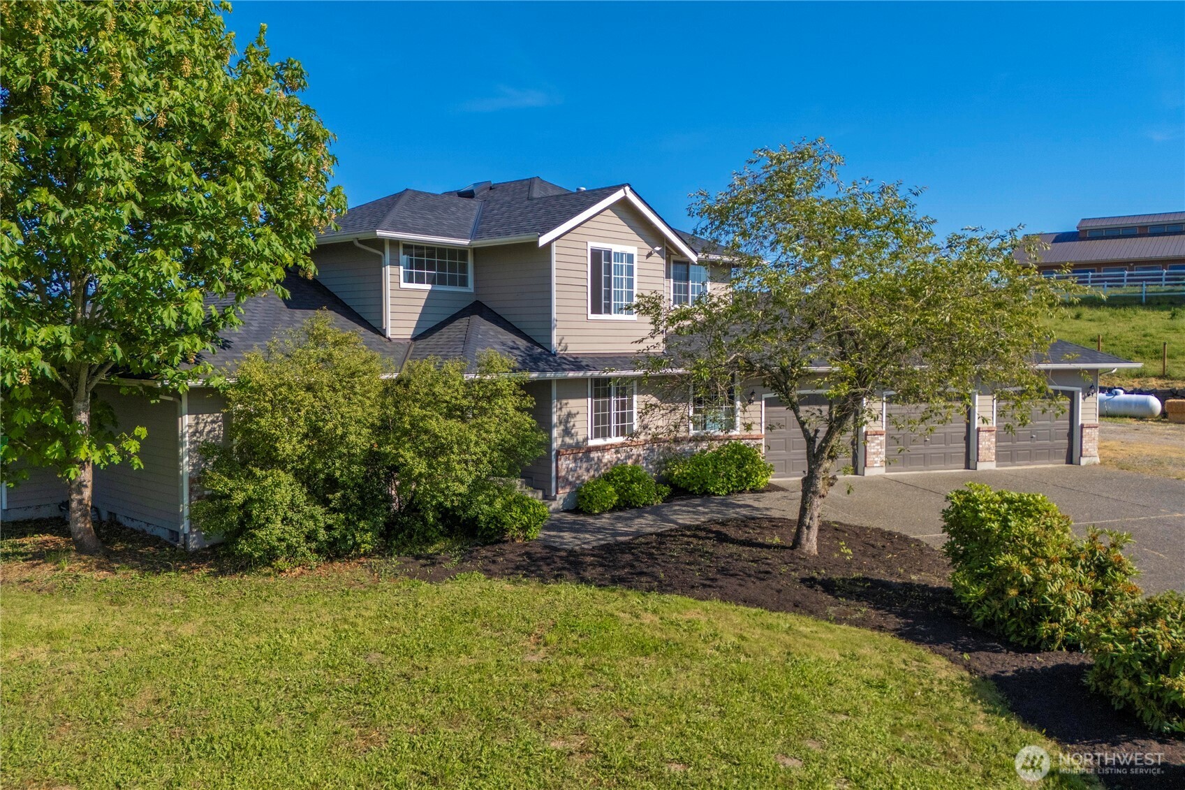 9906 328th Street East Graham, WA 98338 - Photo 34 of 38 a front view of a house with a yard