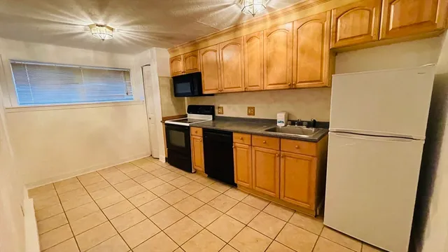 a kitchen with stainless steel appliances a refrigerator sink and microwave