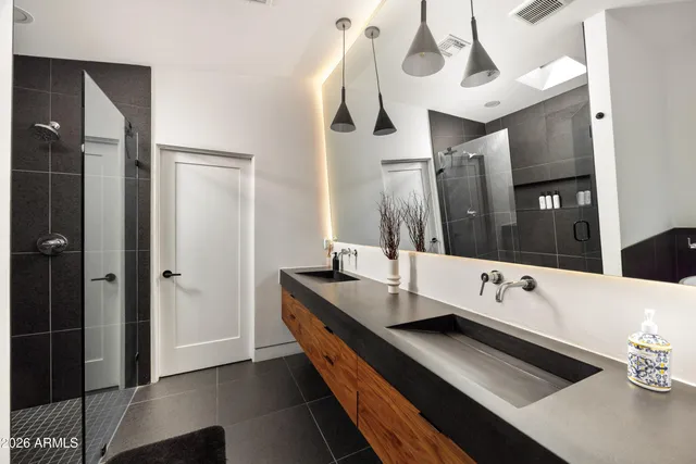 a bathroom with a granite countertop sink toilet and shower