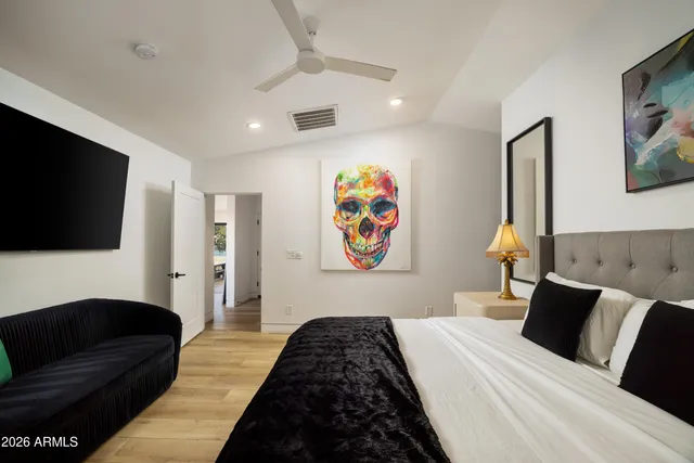 a bedroom with a large bed and a large window