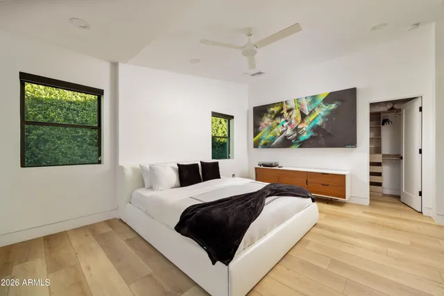 a bedroom with two beds and a window