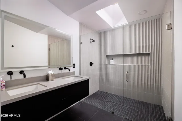 a bedroom with a large bed and a flat screen tv