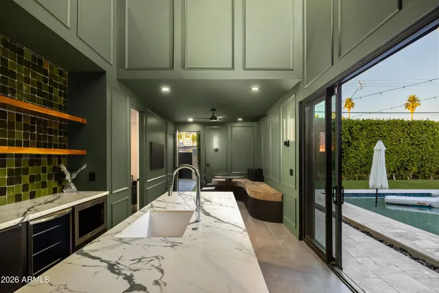 a kitchen with stainless steel appliances kitchen island granite countertop a refrigerator and a sink