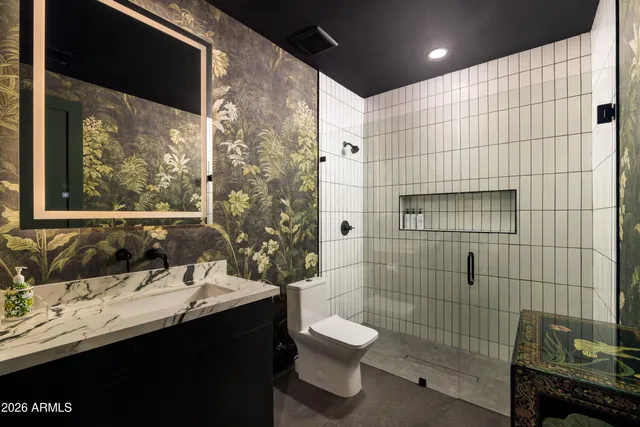 a bedroom with a bed and painting on the wall