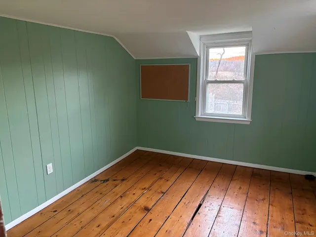 a view of a room with wooden floor and fan