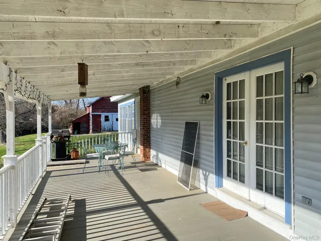 a balcony with couch and wooden floor