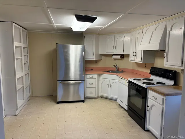 a kitchen with a stove a refrigerator and a sink