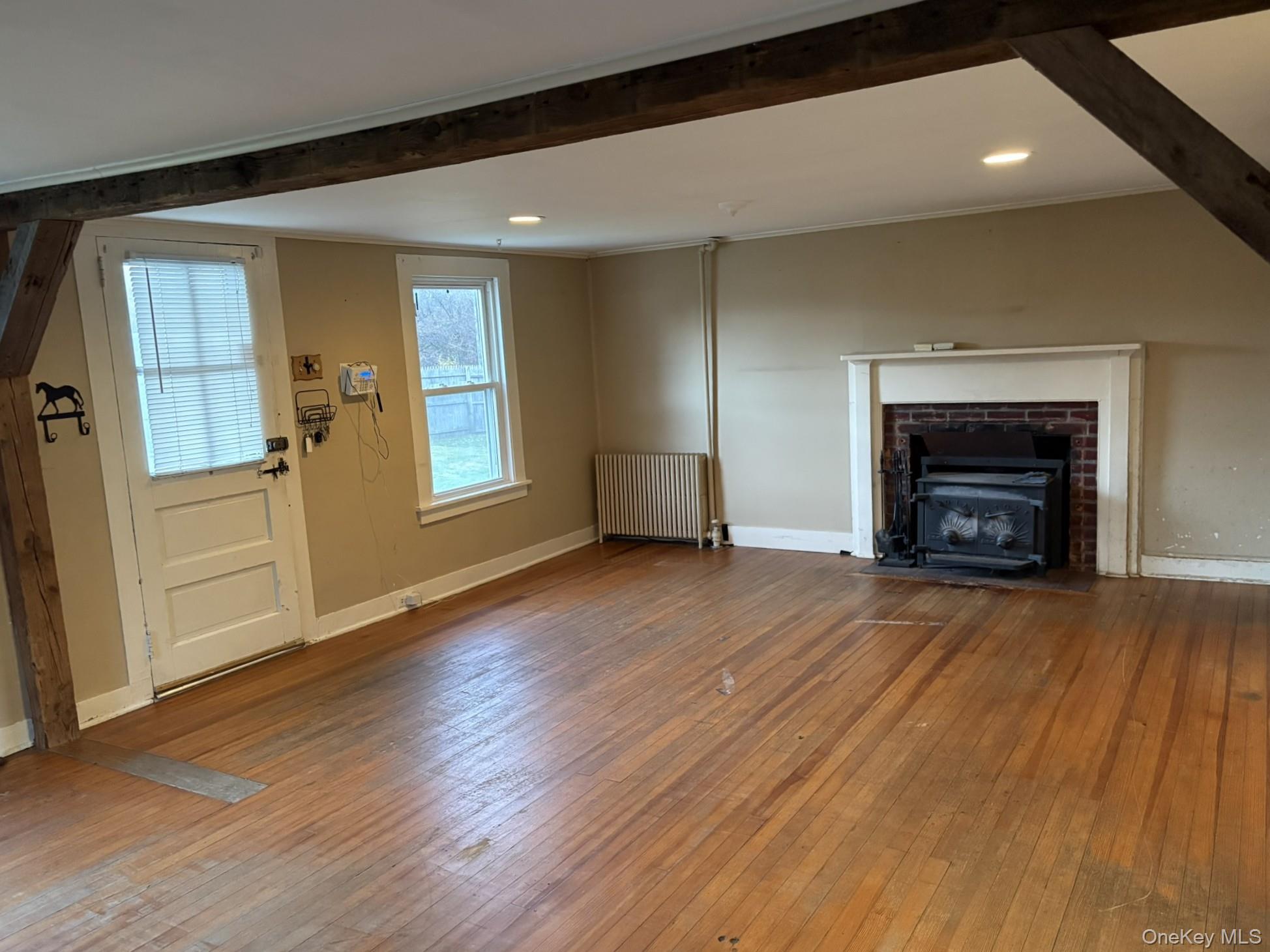 15 Sharon Valley Road Sharon, CT 06069 - Photo 10 of 26 an empty room with wooden floor fireplace and windows