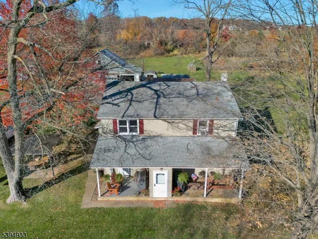 a view of a stone house with a yard