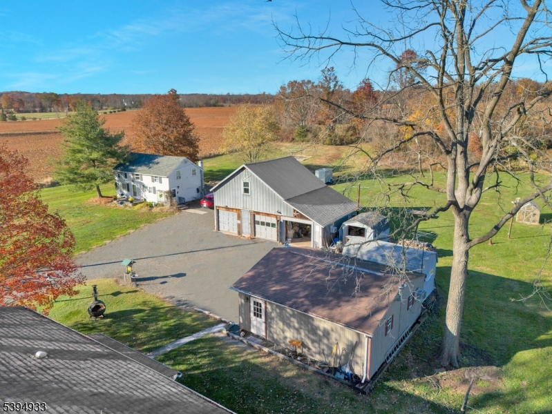 58 Dunkard Church Road Stockton, NJ 08559 - Photo 5 of 26 a view of a white house next to a yard with a lake view