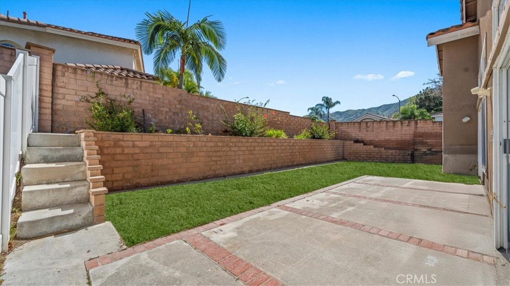 1671 Dominguez Ranch Road Corona, CA 92878 - Photo 28 of 42 The private backyard features a spacious patio area and low-maintenance landscaping, offering a great setting for outdoor dining or relaxation.