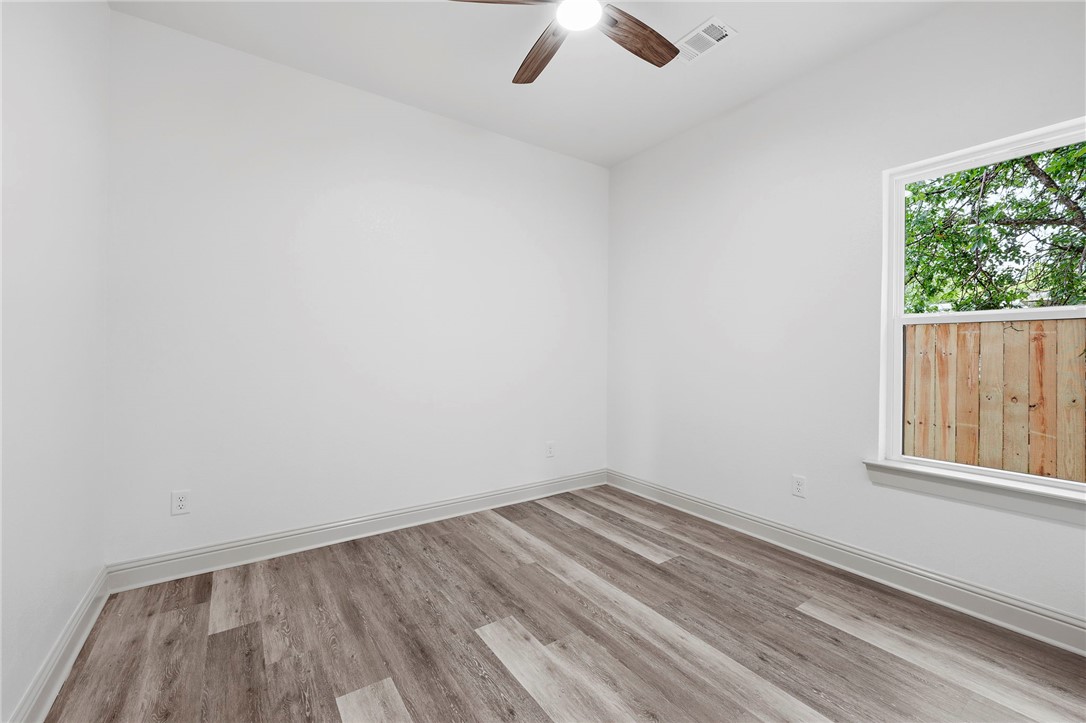 505 Legion Court Bryan, TX 77803 - Photo 15 of 21 an empty room with a window and a ceiling fan