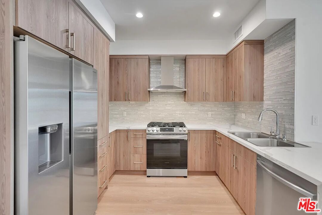 14419 Riverside Drive, Unit 304 Sherman Oaks, CA 91423 - Photo 1 of 1 a kitchen with a stove sink and refrigerator