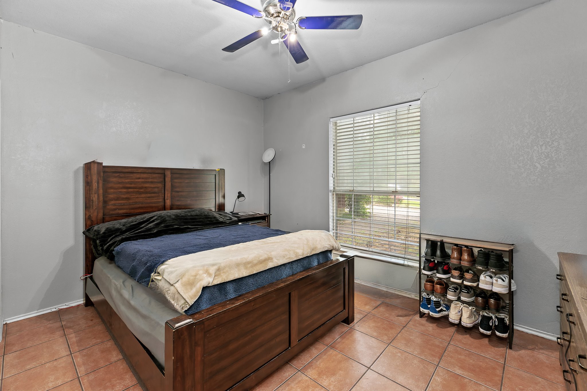 11737 Rydalwater Lane Austin, TX 78754 - Photo 15 of 40 Spacious room featuring tile flooring, a ceiling fan with integrated lighting, and a large window with horizontal blinds