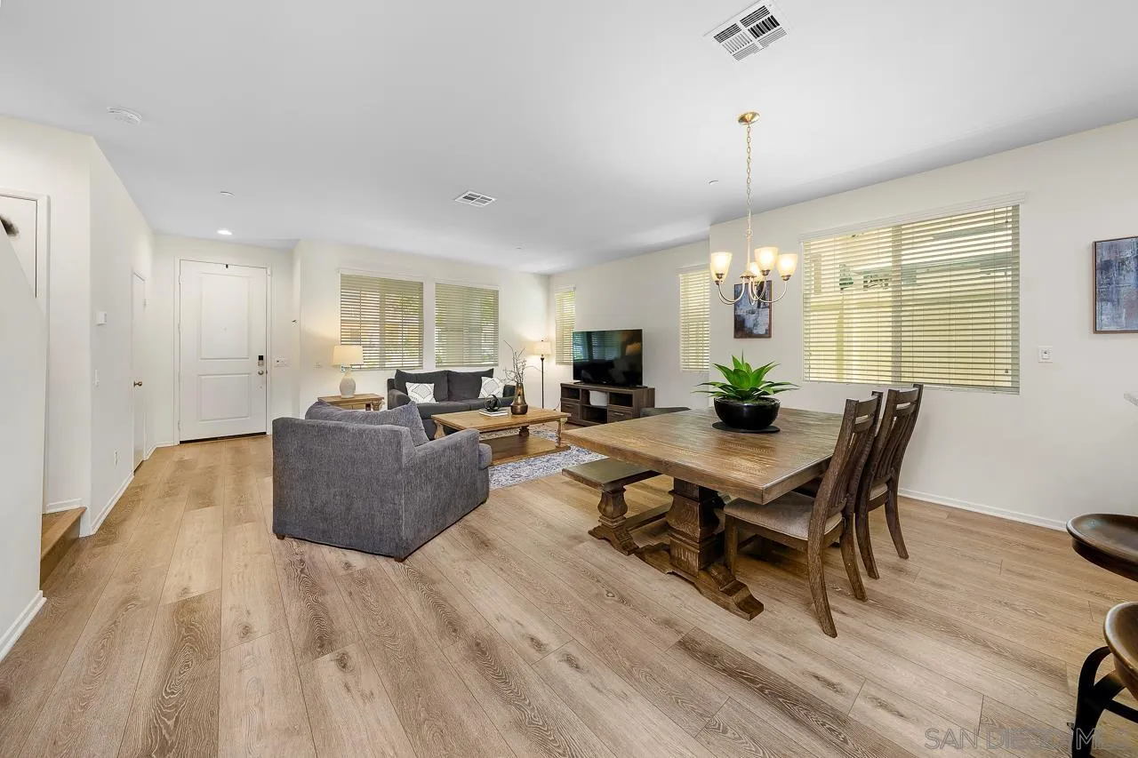 1290 Santa Victoria Road, Unit 2 Chula Vista, CA 91913 - Photo 13 of 41 a living room with furniture dining table and a wooden floor