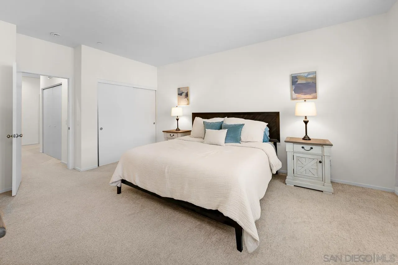 1290 Santa Victoria Road, Unit 2 Chula Vista, CA 91913 - Photo 19 of 41 a bedroom with a bed and a night stand