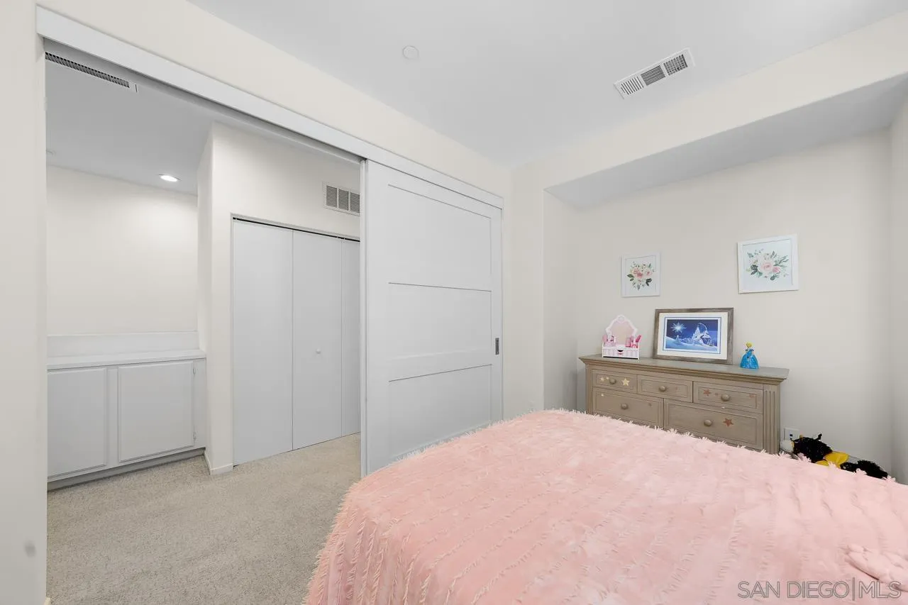 1290 Santa Victoria Road, Unit 2 Chula Vista, CA 91913 - Photo 28 of 41 a bedroom with a bed and a chandelier