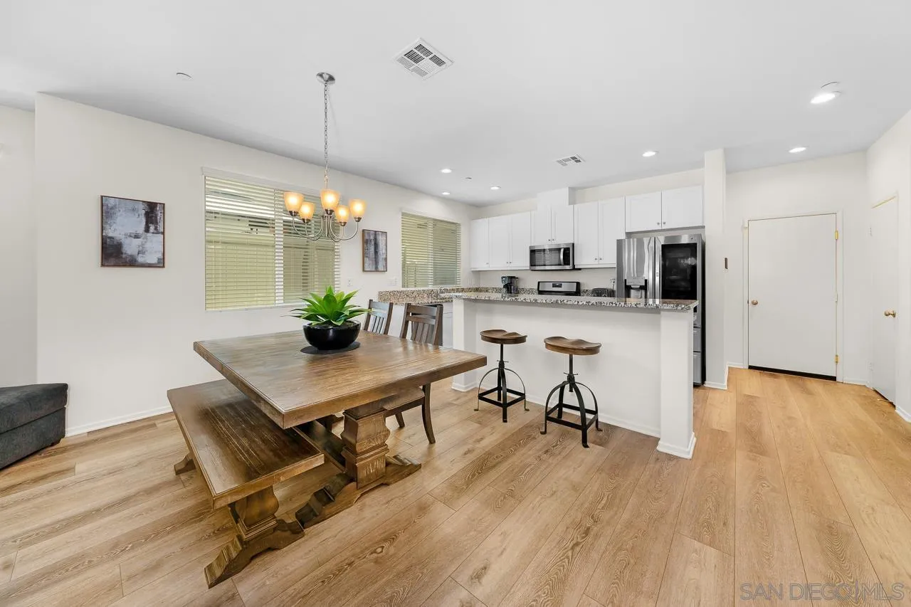 1290 Santa Victoria Road, Unit 2 Chula Vista, CA 91913 - Photo 7 of 41 a view of a dining room with furniture and a chandelier